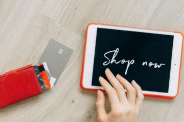 Close-up of a digital shopping theme with a tablet and credit cards, highlighting a modern retail experience.