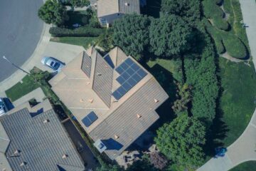 An aerial view showcasing modern suburban houses equipped with solar panels for renewable energy.
