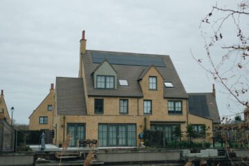 A picturesque canal-side house in Hoofddorp, Holland showcasing modern architecture.